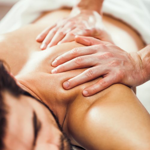 Young man is having massage on spa treatment.